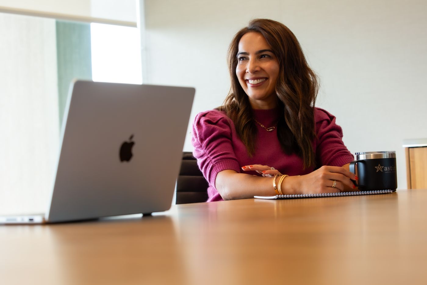 A member of the Astira team working at a laptop