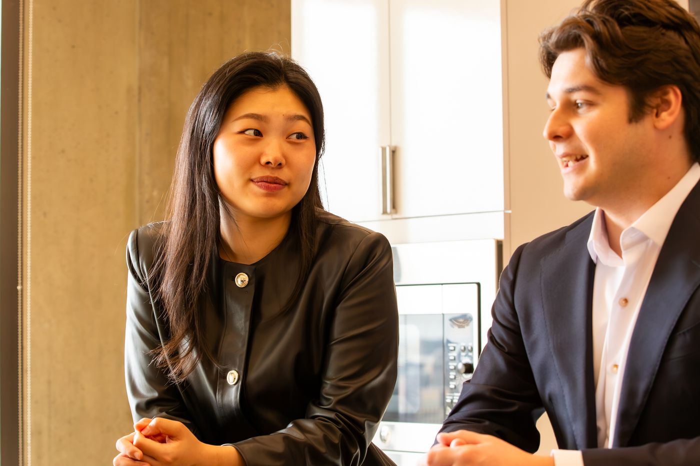 Two Astira colleagues in conversation at the office