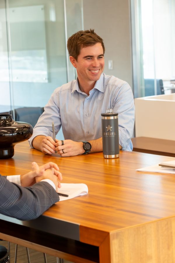 A member of the Astira team at the conference table