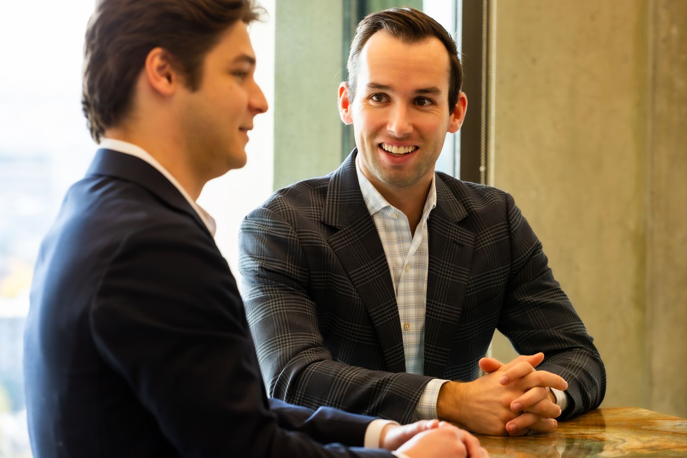 Two members of the Astira team at the conference table